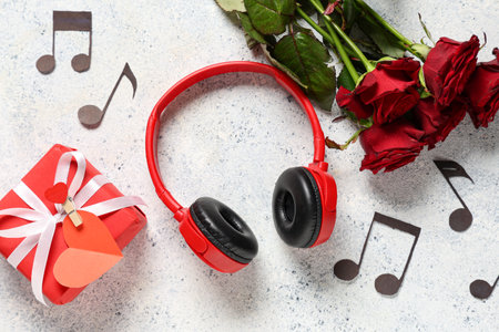 Headphones with notes, gift box and roses on grunge background. Valentine's Day celebrationの写真素材