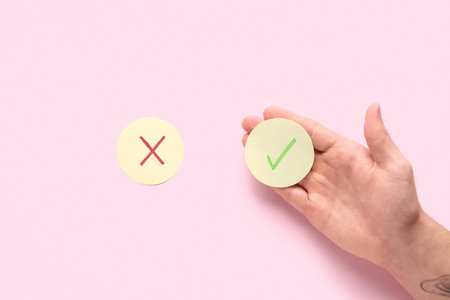 Male hand and rating marks on pink background. Survey concept