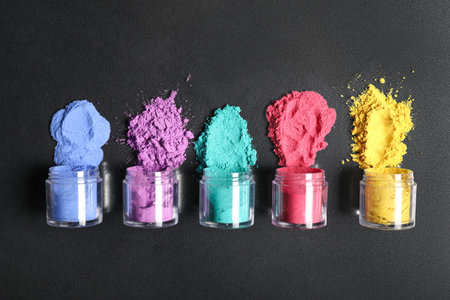 Jars of powder pigments on black backgroundの写真素材