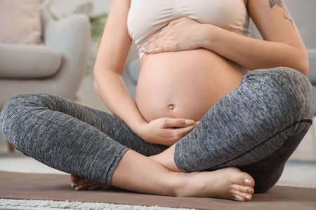 Sporty young pregnant woman at home