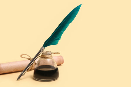 Scroll with nib pen and inkwell on beige backgroundの写真素材