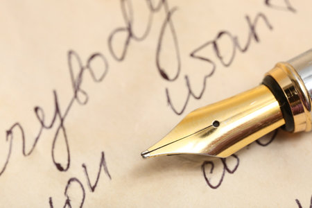 Old paper sheet with letters and nib pen, closeupの写真素材