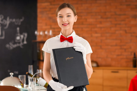 Young waitress with menu in restaurant