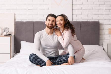 Happy couple hugging in bedroomの写真素材