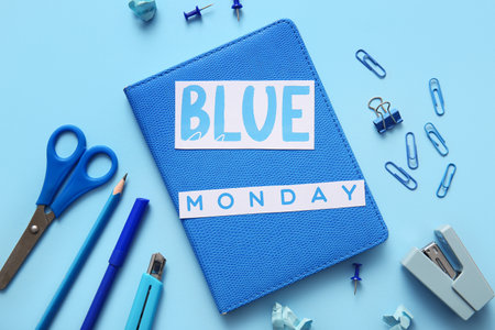 Notebook with text BLUE MONDAY and office stationeryの写真素材