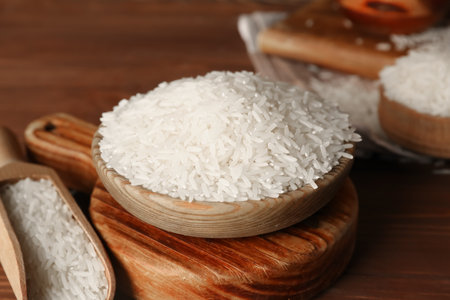 Scoop and bowl of raw rice on table. Closeupの写真素材