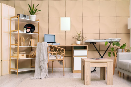 Interior of living room with synthesizer, tables and shelf unitの写真素材