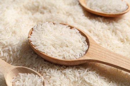 Wooden spoons with raw rice, closeupの写真素材
