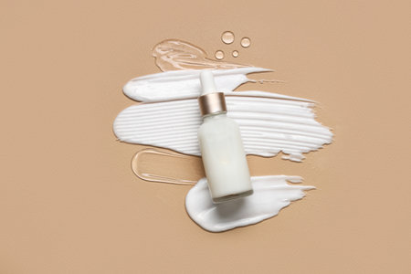 Samples and bottle with cosmetic products on beige backgroundの写真素材