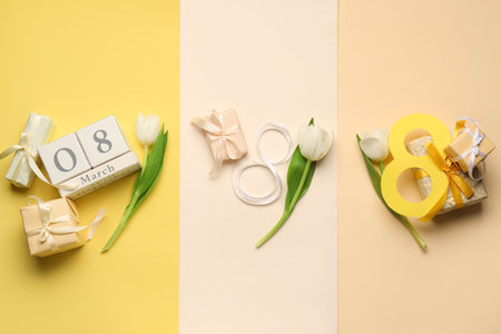 Figure 8 made of ribbon with cube calendar, gift boxes and beautiful tulips on colorful background. International Women's Day celebrationの写真素材