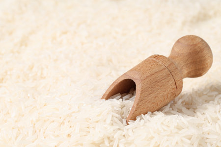 Closeup view of wooden scoop and raw rice as background, closeupの写真素材