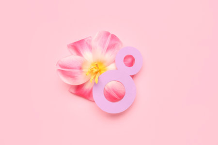 Figure 8 made of paper and flower for Women's Day celebration on pink background
