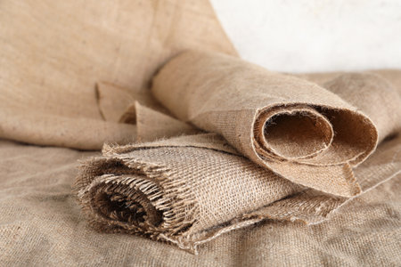 Rolls of burlap fabric on light backgroundの写真素材