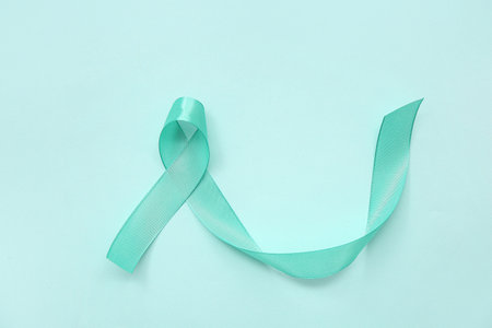 Turquoise ribbon on color background. Cervical Health Awareness Monthの写真素材