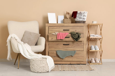 Interior of messy dressing room with armchair, commode and stand