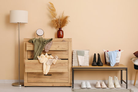 Interior of dressing room with drawers, bench and lampの写真素材