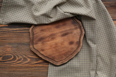 Gray checkered tablecloth with board on wooden backgroundの写真素材