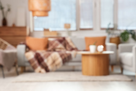 Cozy sofas, armchair and coffee table in interior of living room. Blurred viewの写真素材