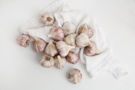 Many fresh garlic on white backgroundの写真素材