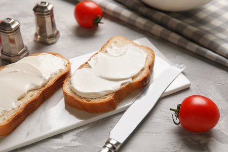 Tasty bruschetta with cheese and fresh tomatoes on gray background. Closeupの写真素材