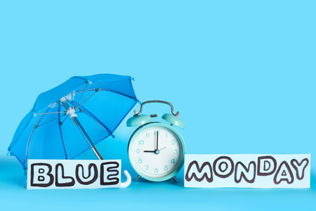 Text BLUE MONDAY with umbrella and alarm clock