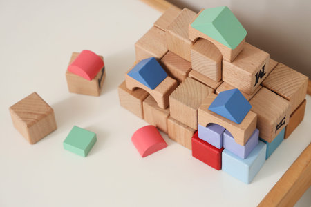 Cubes on table near wall in children's playroom, closeup