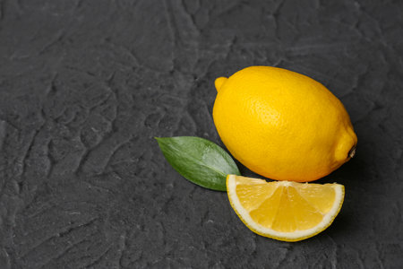 Fresh ripe lemon and leaf on black backgroundの写真素材