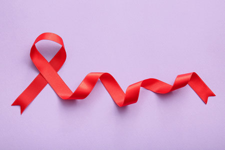 Red ribbon on lilac backgroundの写真素材