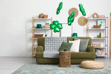 Interior of living room decorated for St. Patrick's Day with sofa, shelf units and balloons