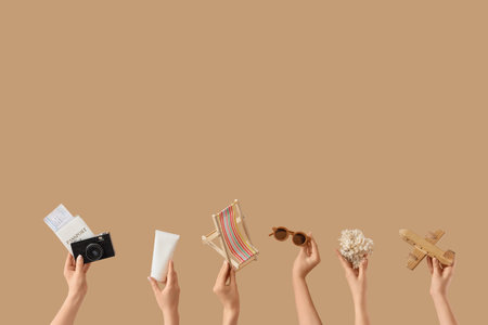Female hands with beach accessories on beige backgroundの写真素材