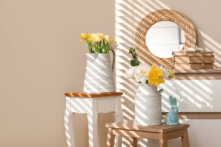 Vases with flowers on stools in room