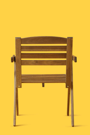 Stylish wooden chair on yellow backgroundの写真素材