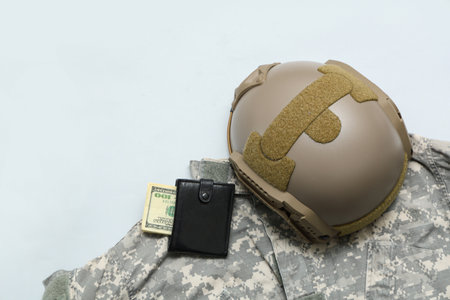 Wallet with money and soldier's uniform on white backgroundの写真素材