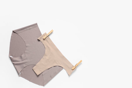 Female panties with clothespins on white backgroundの写真素材