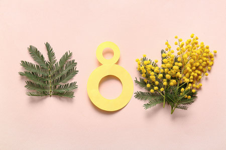 Figure 8 made of paper and beautiful yellow mimosa flowers on beige backgroundの写真素材