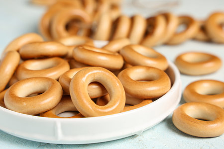 Plate with tasty bagels, closeup