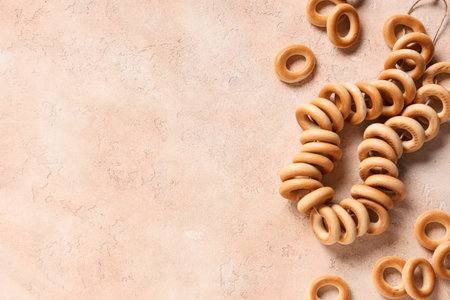 String of tasty bagels on beige grunge background