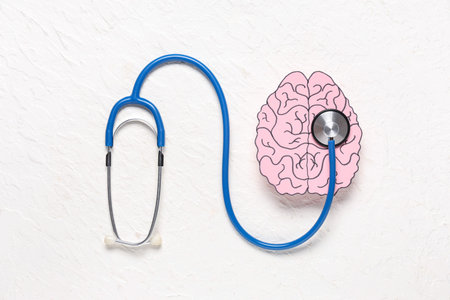 Paper human brain with stethoscope on white background. Cancer concept