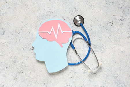 Paper human head with brain, cardiogram and stethoscope on light grunge background. Cancer conceptの写真素材