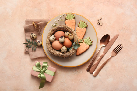 Beautiful table setting with sweet cookies, eggs, gift box and gypsophila flowers on beige...