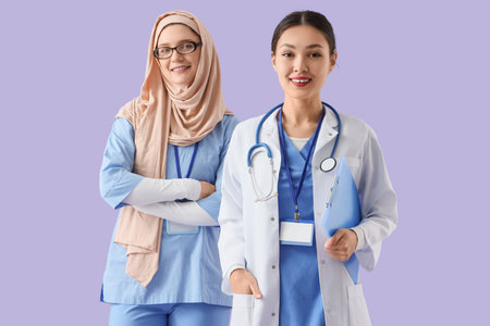 Female doctors smiling on lilac background. International Nurses Dayの写真素材