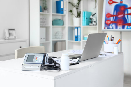 Doctor's workplace with laptop and sphygmomanometer in medical officeの写真素材