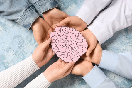 Women holding paper human brain on blue grunge background. Cancer concept