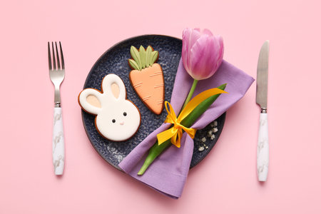 Beautiful table setting with sweet cookies and tulip flower on pink background