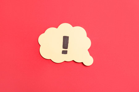 Speech bubble with exclamation mark on red background