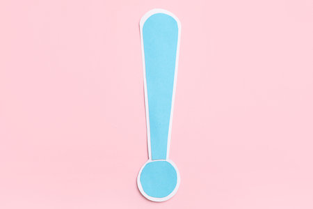 Paper exclamation mark on pink backgroundの写真素材