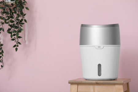 Air humidifier on table near pink wall, closeupの写真素材