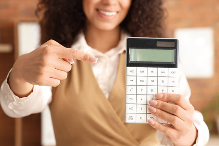 African-American female accountant holding calculator, closeupの写真素材