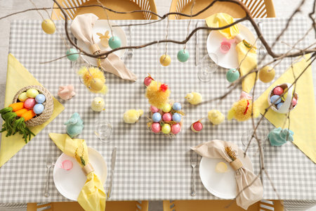 Beautiful table setting with decorative chickens and Easter eggs in room