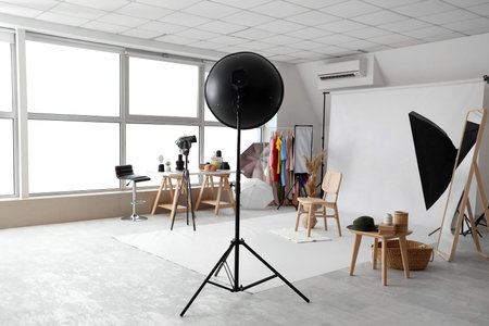 Chair and vase with pampas grass on white backdrop in photo studioの写真素材